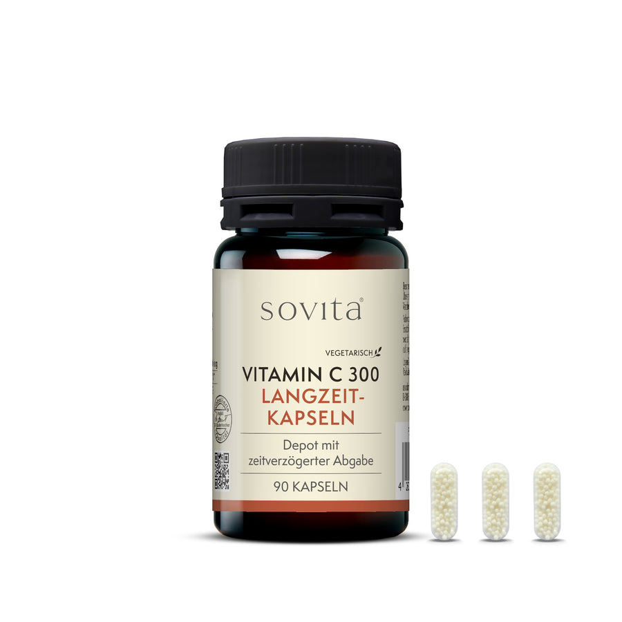 Produktabbildung der sovita Vitamin C 300 Langzeit-Kapseln mit drei transparenten Kapseln, die kleine weiße Kügelchen enthalten